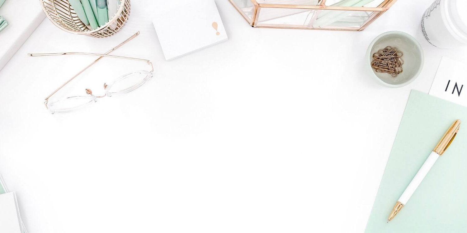 mint green desk accessories flat lay on a white background