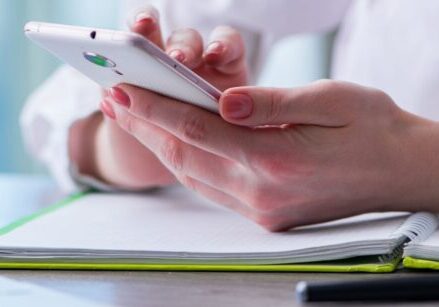 person holding a phone for blog post "Appointment Funnels 101: How to Get Way More Sales Calls and Grow Your Business with Ease"