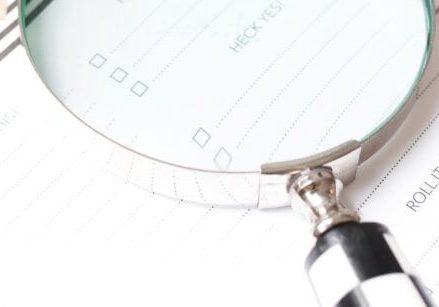 magnifying glass on a day planner highlighting a keyword