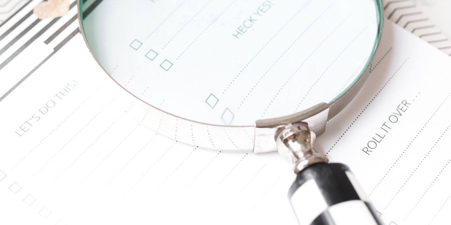 magnifying glass on a day planner highlighting a keyword