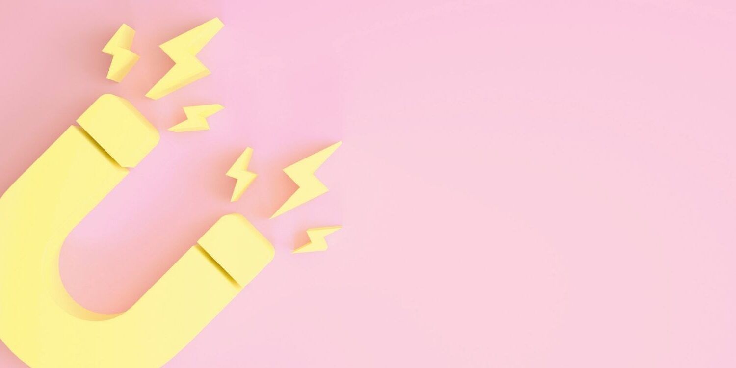graphic illustration of a yellow magnet on a pink background for blog post "How to Deliver & Promote Your Lead Magnet"