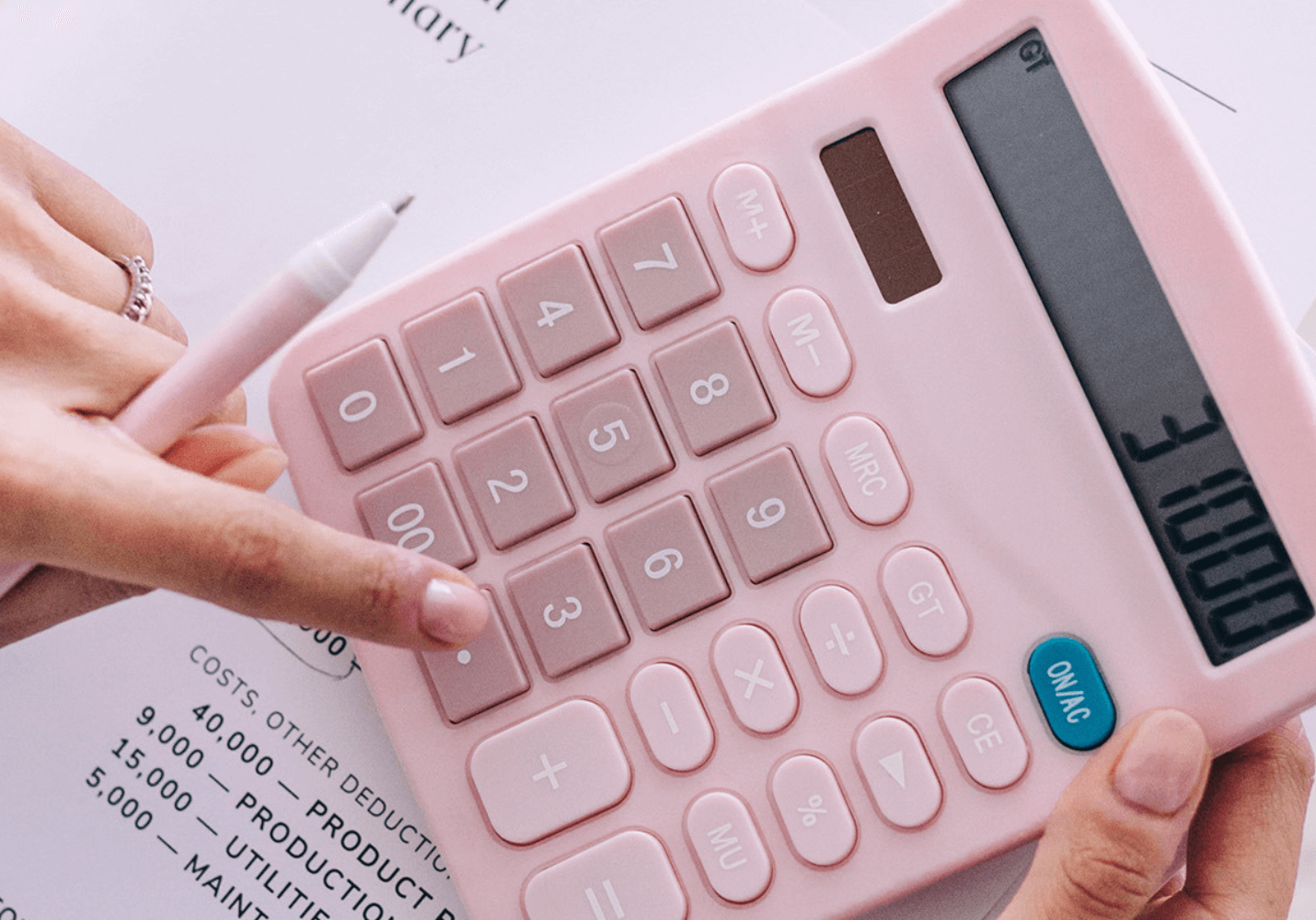 how to price your coaching services: a life coach using a calculator