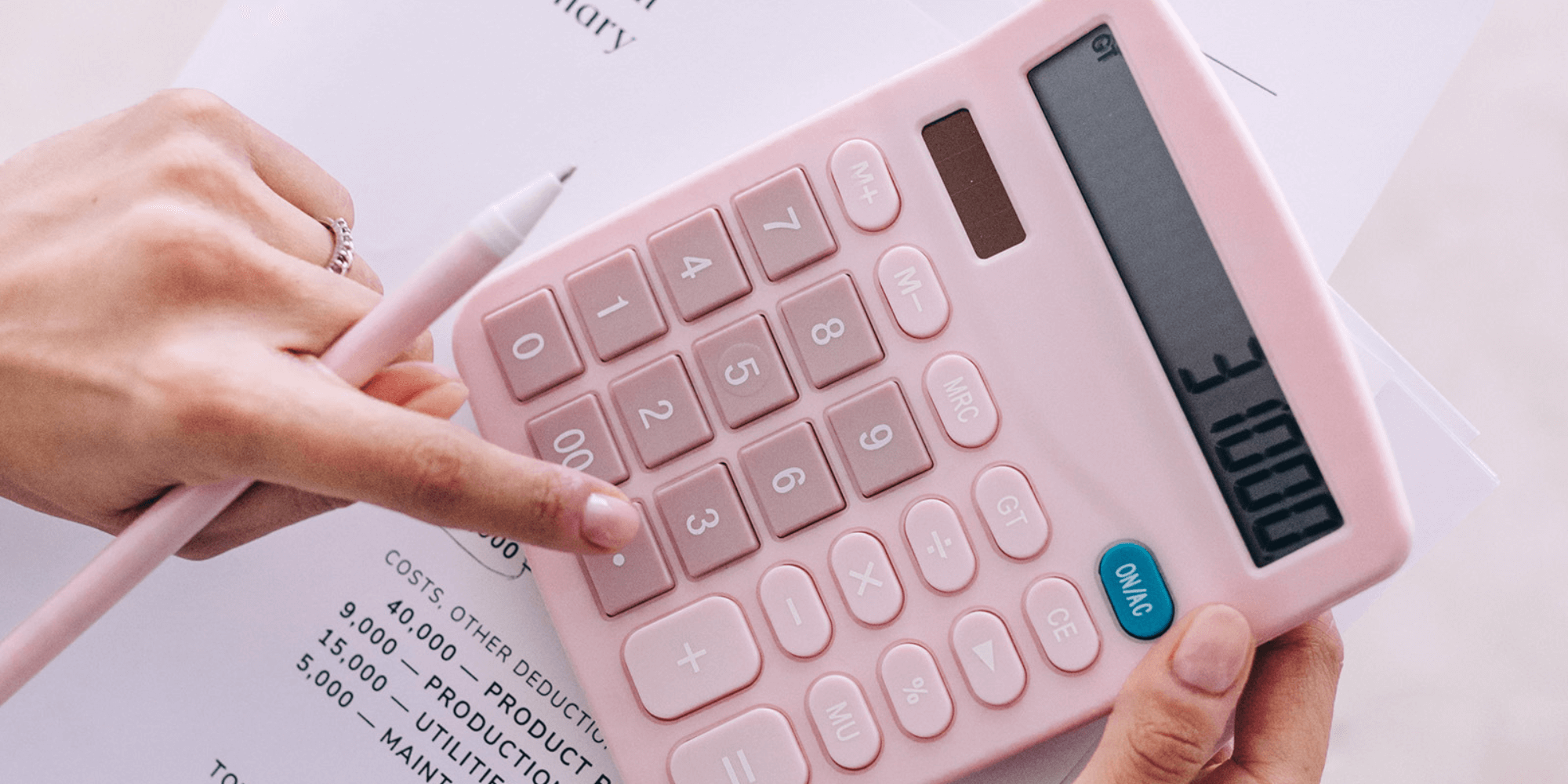 how to price your coaching services: a life coach using a calculator