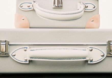 suitcases piled on top of a car