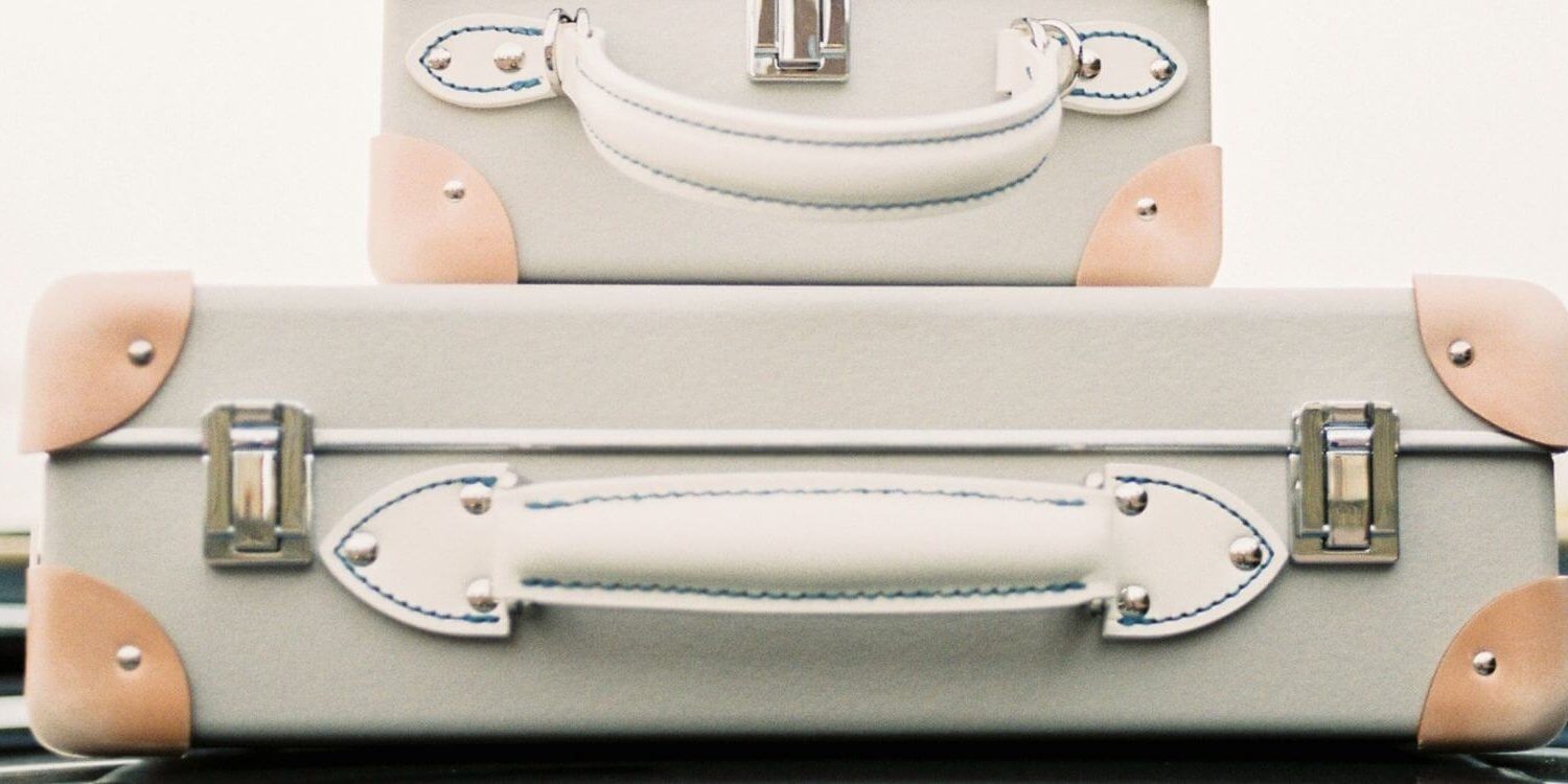 suitcases piled on top of a car