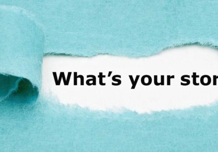 turquoise piece of paper torn to reveal "what's your story" typed on white paper behind it.