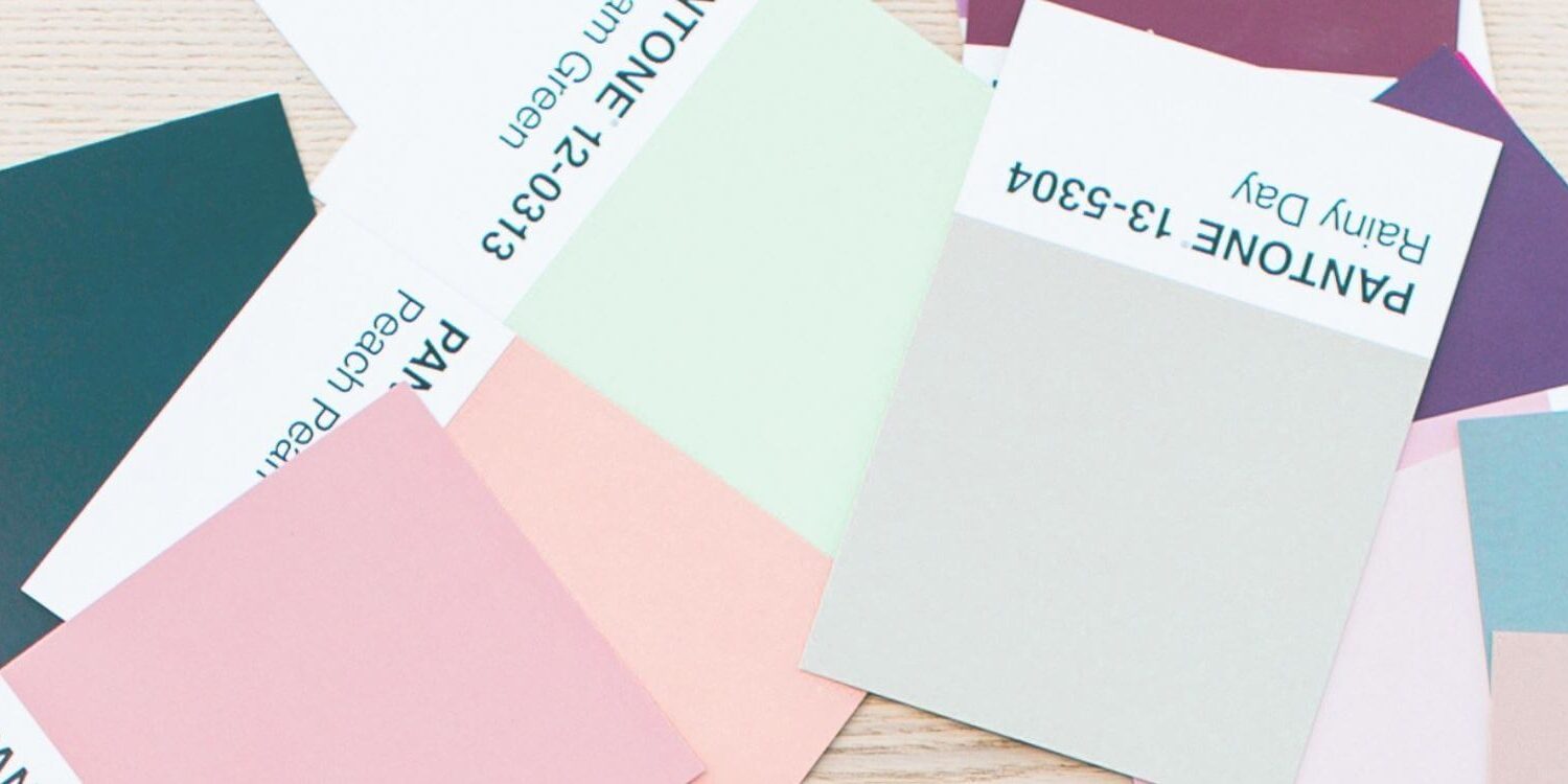 pile of pink, gray, teal, blue color swatches from pantone