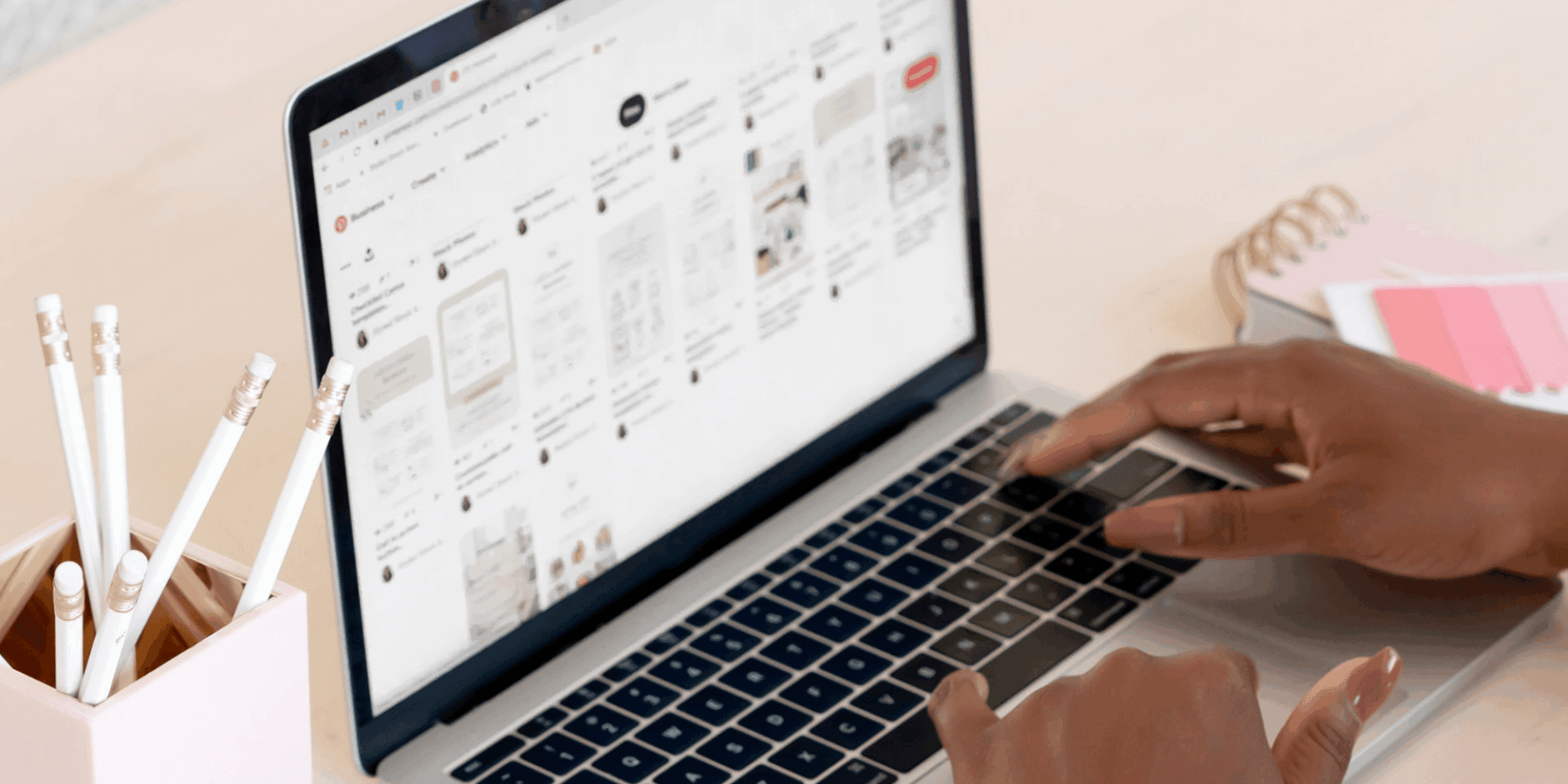 Hands typing on a keyboard as someone is building a website