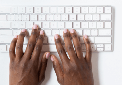 Hands typing on a keyboard