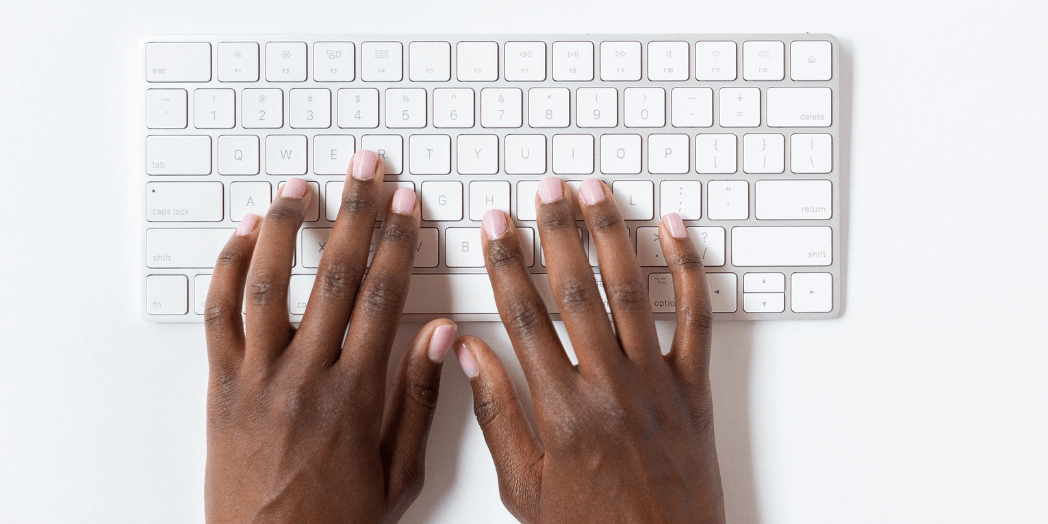 Hands typing on a keyboard