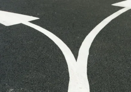 two arrows making a Y and pointing in different directions this or that