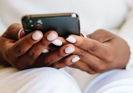 woman's hands holding a cell phone