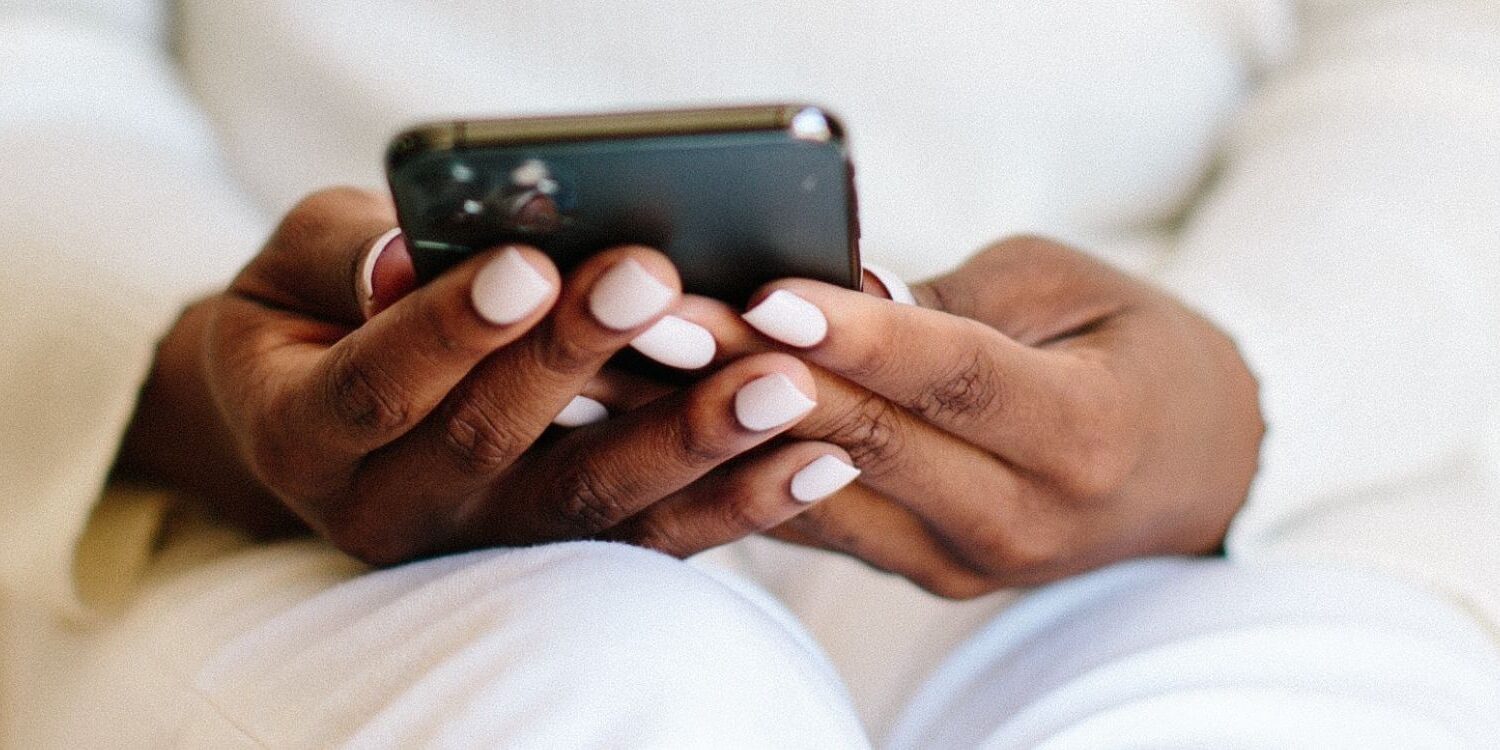 woman's hands holding a cell phone