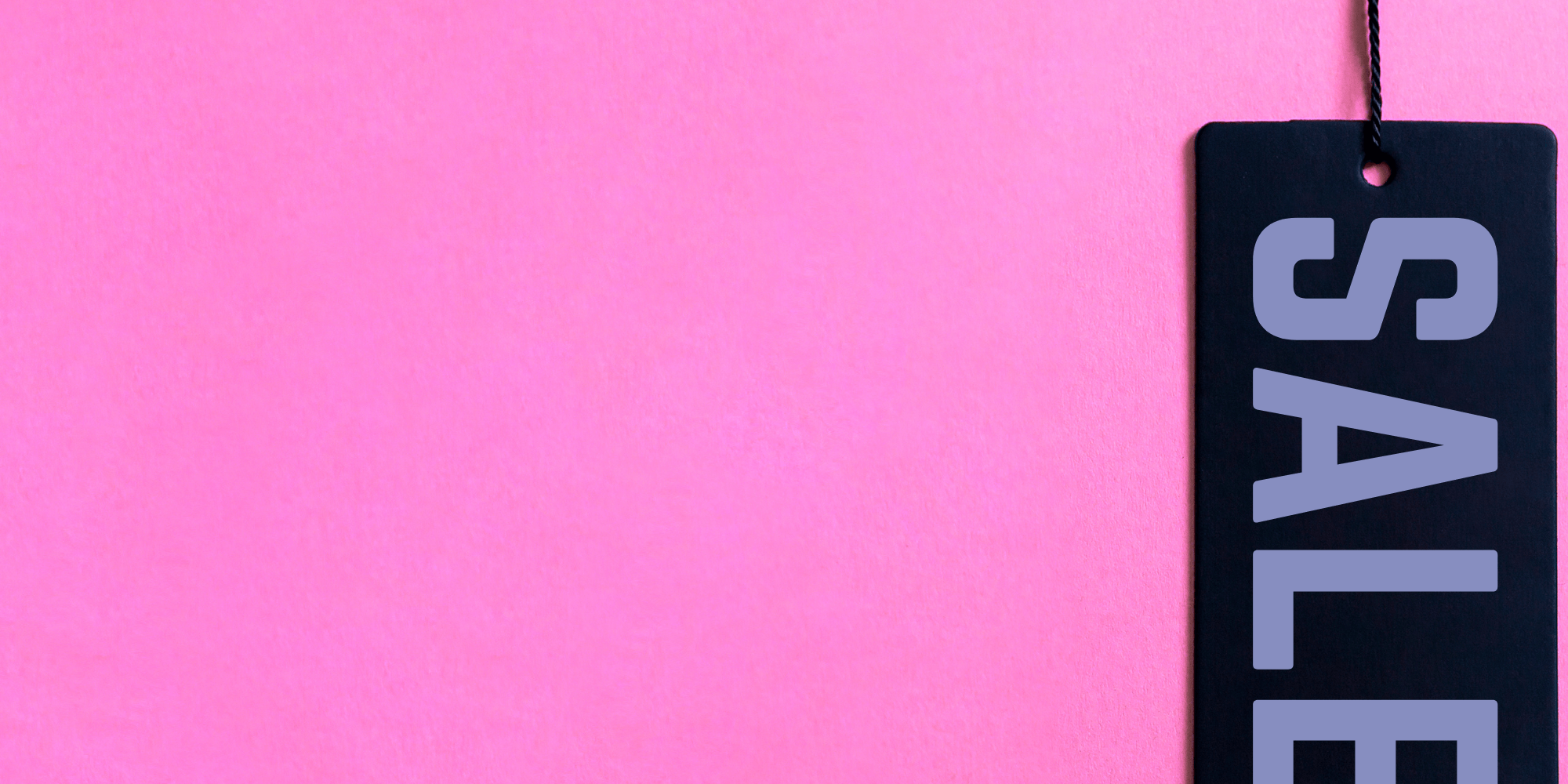 Black Friday sale tag hanging against a hot pink background.