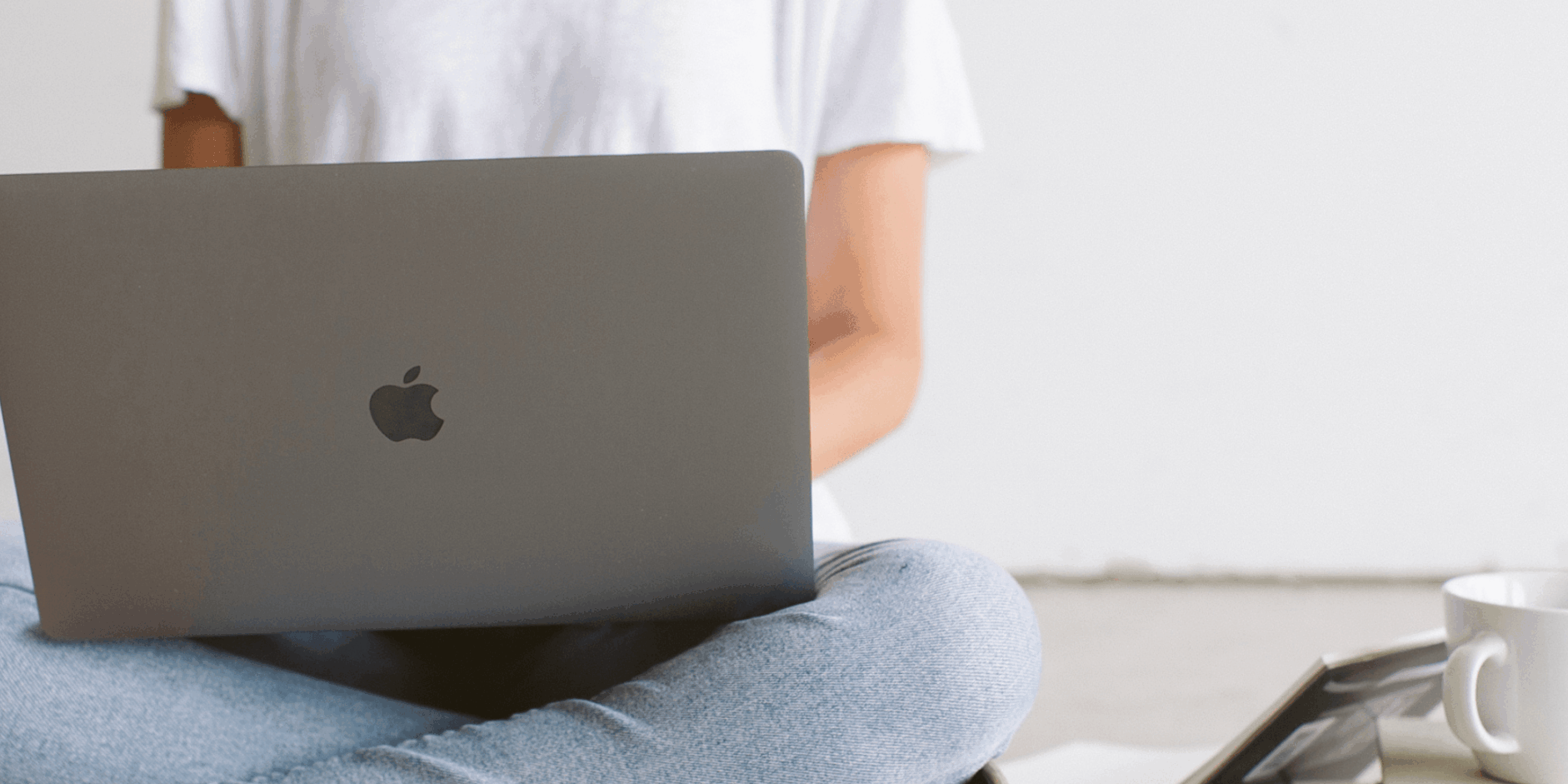 A business owner working on her laptop and maintaining consistency in marketing