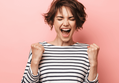 Woman doing an excited fist bump to crush content marketing overwhelm
