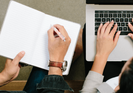arial view of man and woman sitting next to each other working
