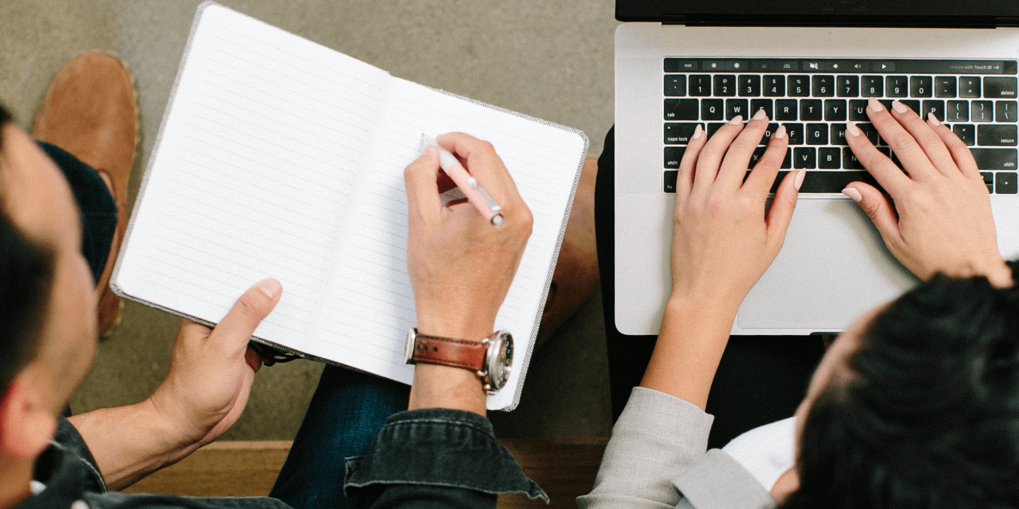 arial view of man and woman sitting next to each other working