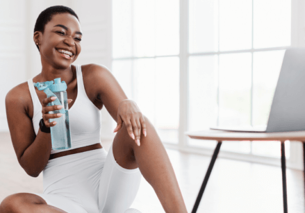 A health coach helping a client virtually with a laptop on the table.