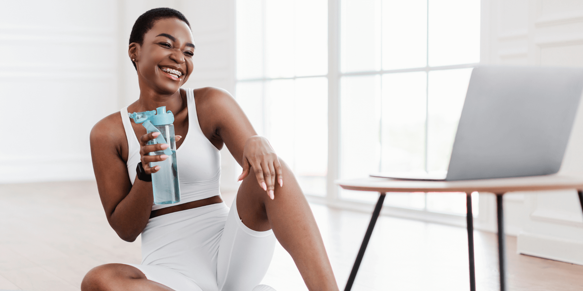 A health coach helping a client virtually with a laptop on the table.