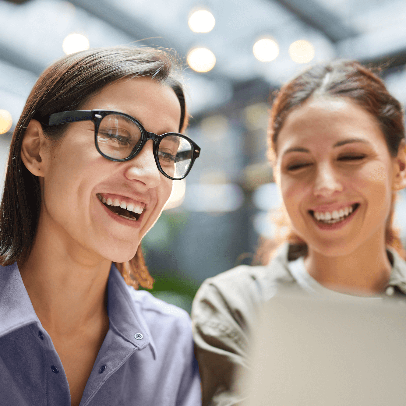 two women sitting at laptop working on computer - marketing coaching