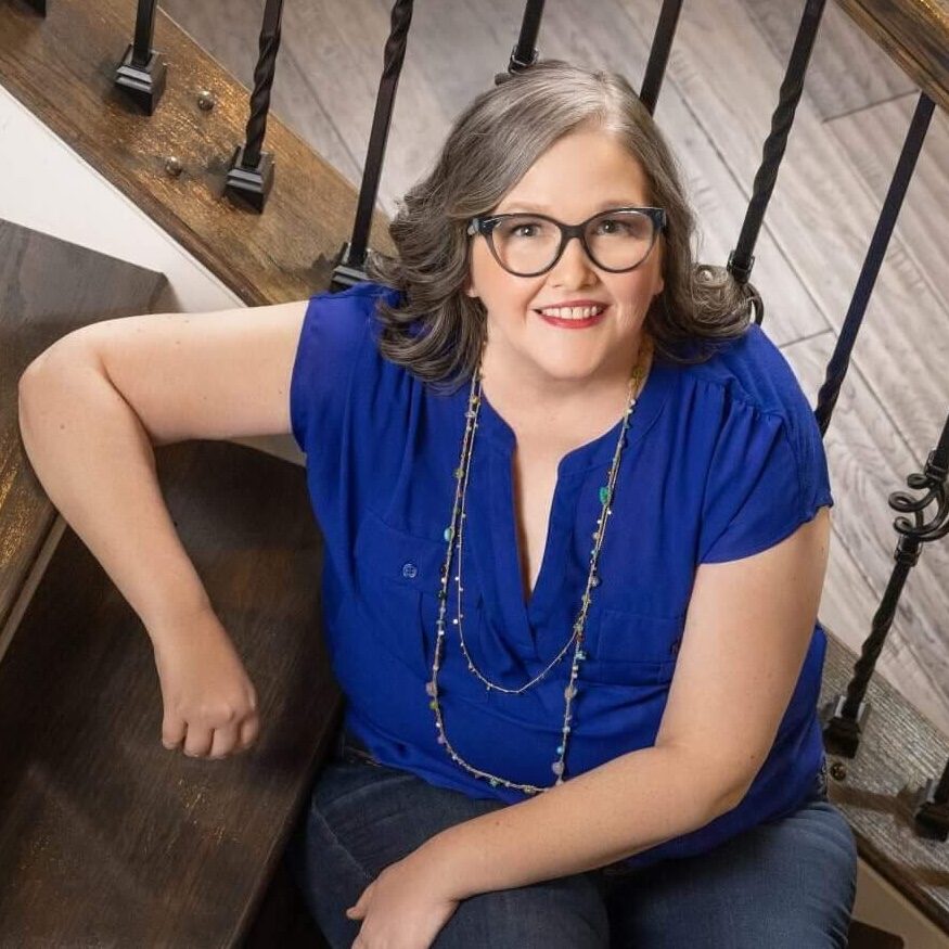 Rachel Gaddis Career Coach Sitting on Stairs Wearing Blue Blouse