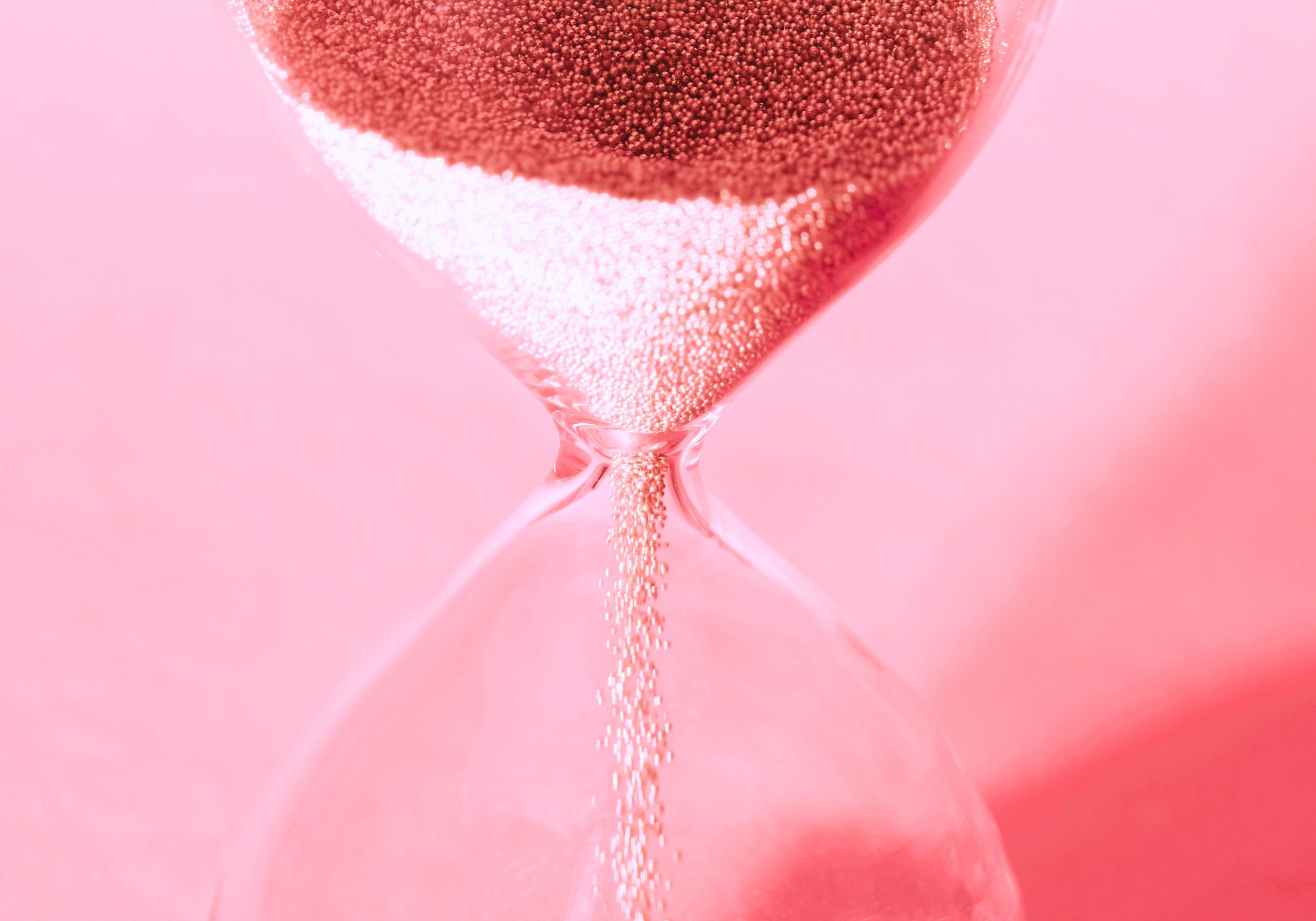 hourglass with sand passing through it representing social media content that disappears vs evergreen searchable content assets that last.