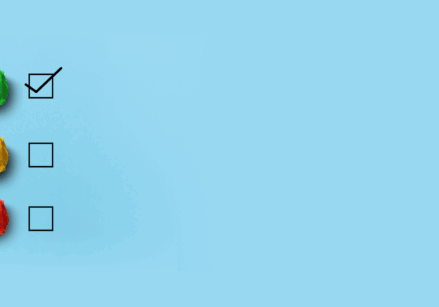 Underpromise overdeliver represented by three crumpled pieces of paper in red yellow and green with sad, meh, and happy faces on the papers. There is a checkmark by the happy face.