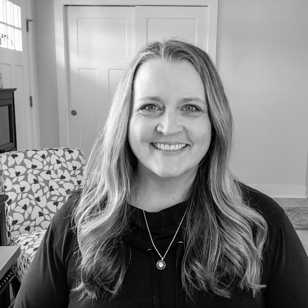Black and white headshot of Heather Stephens, Marketing Coach, a woman with long hair.